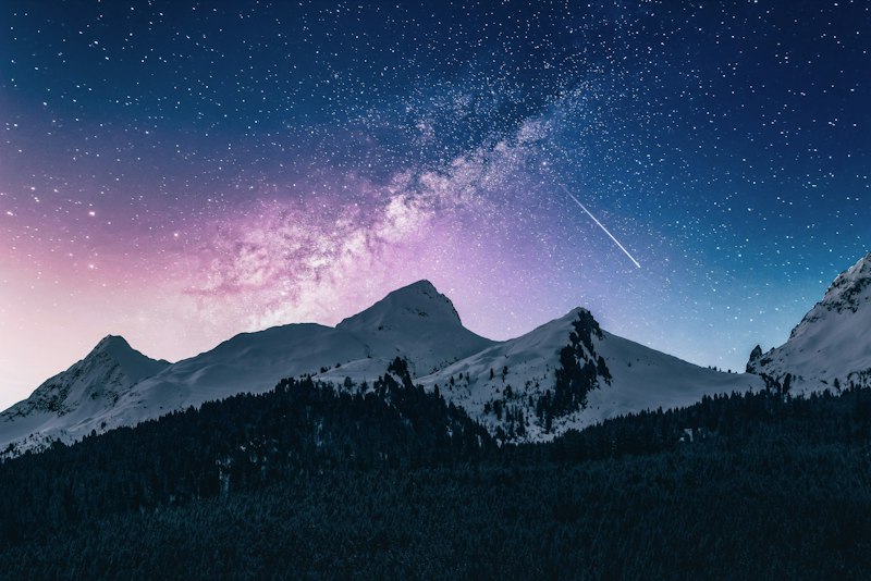 Starry night sky over mountains